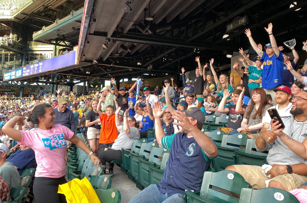 Raven Cruz throws a t-shirt into a crowd of transit fans at the Mariners game. 