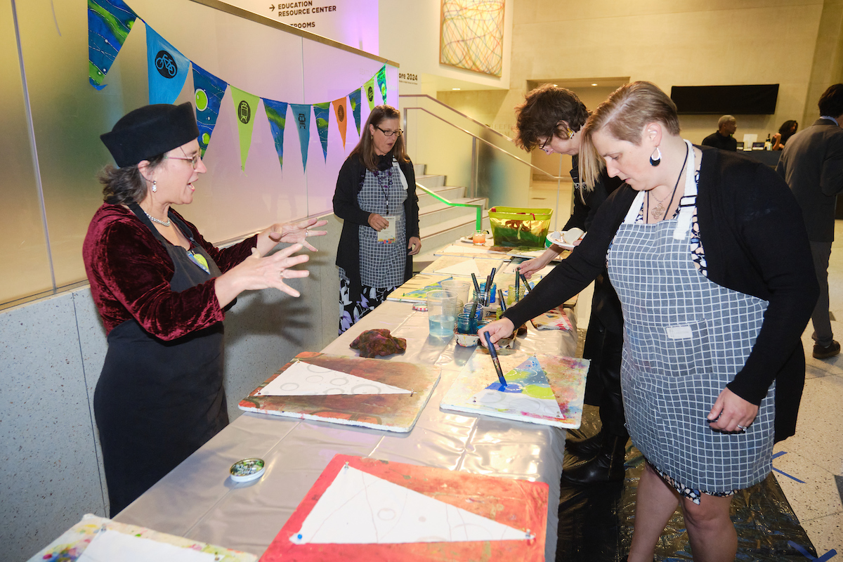 Guests paint flags at an art activity station. 