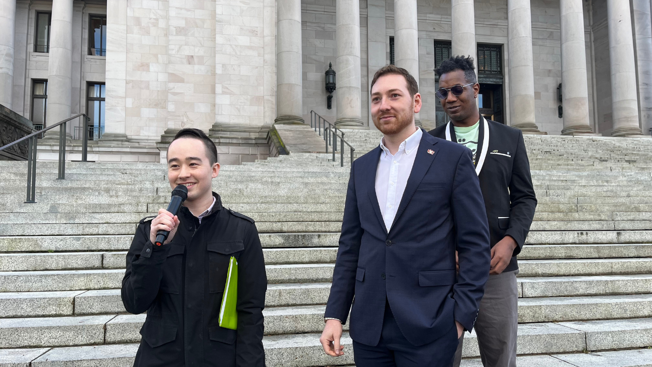 Free to Walk - Ethan Four people stand on the steps of the capitol building in Olympia.