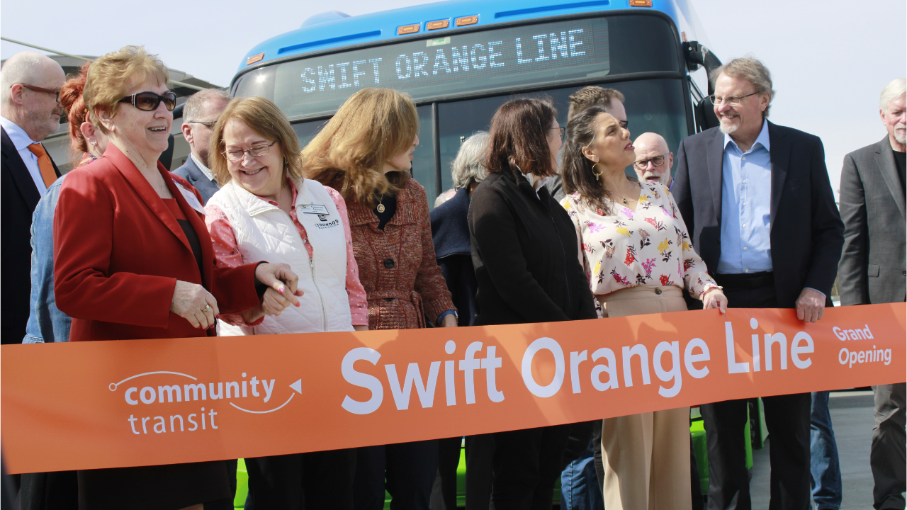 Orange Line Public officials prepare to cut a ribbon at the grand opening of the Swift Orange Line bus rapid transit.