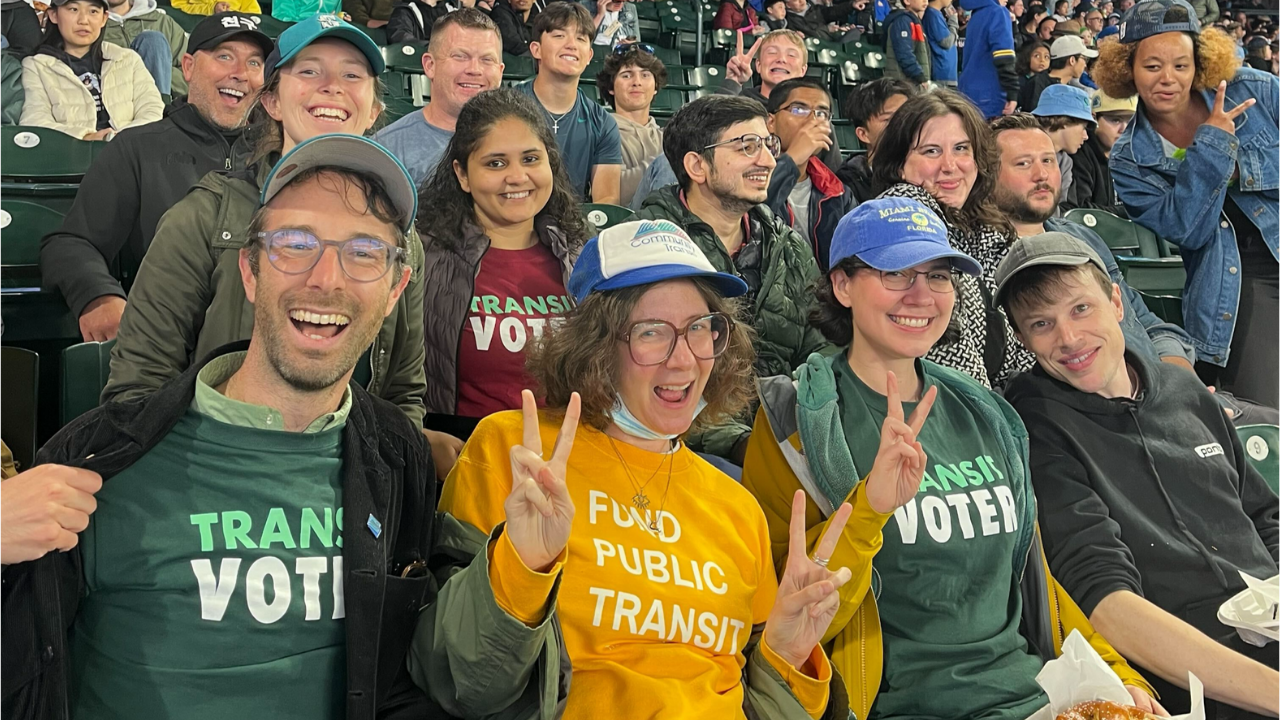 Ride Transit Month TCC staff in transit t-shirts at a Mariners game.