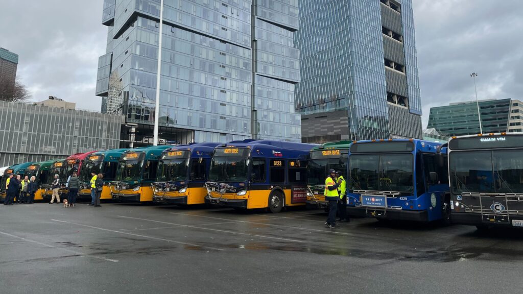 A long line of buses in a parking lot in downtown Seattle