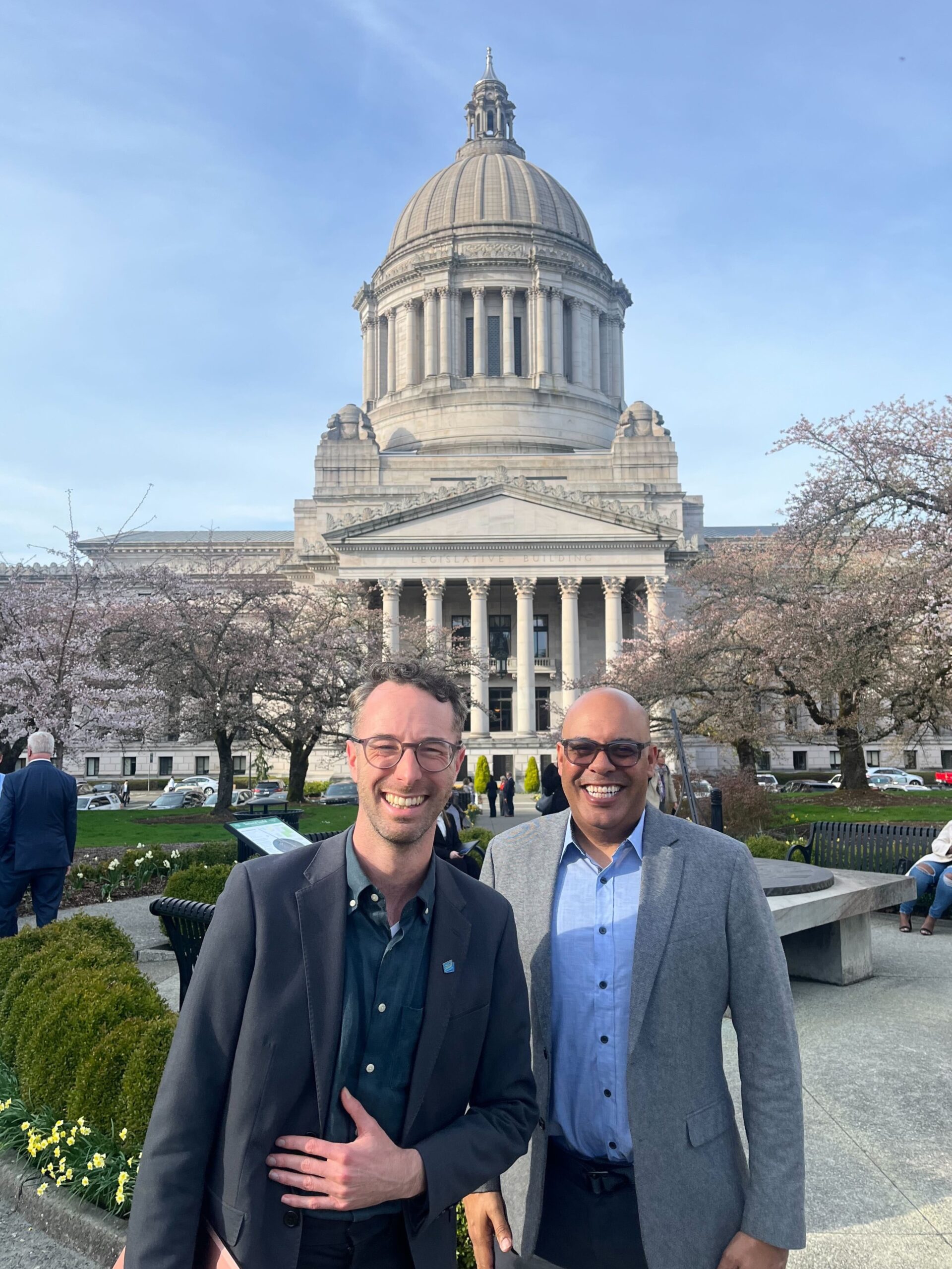 TCC's Executive Director, Kirk Hovenkotter, and the Executive Director of Cascade Bicycle Club, Lee Lambert, pose in front of the Capitol Building in Olympia.