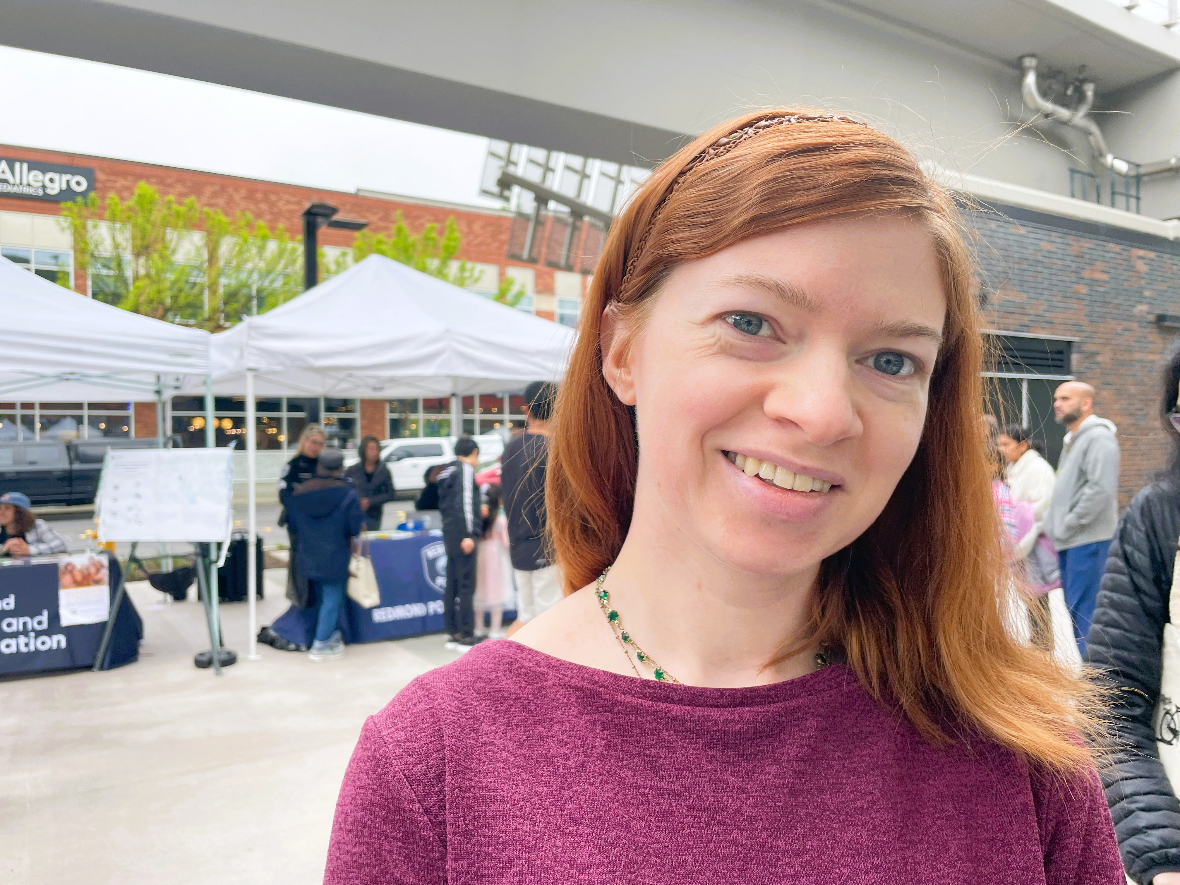 Rachel-Downtown-Redmond A red-headed woman smiles for the camera.