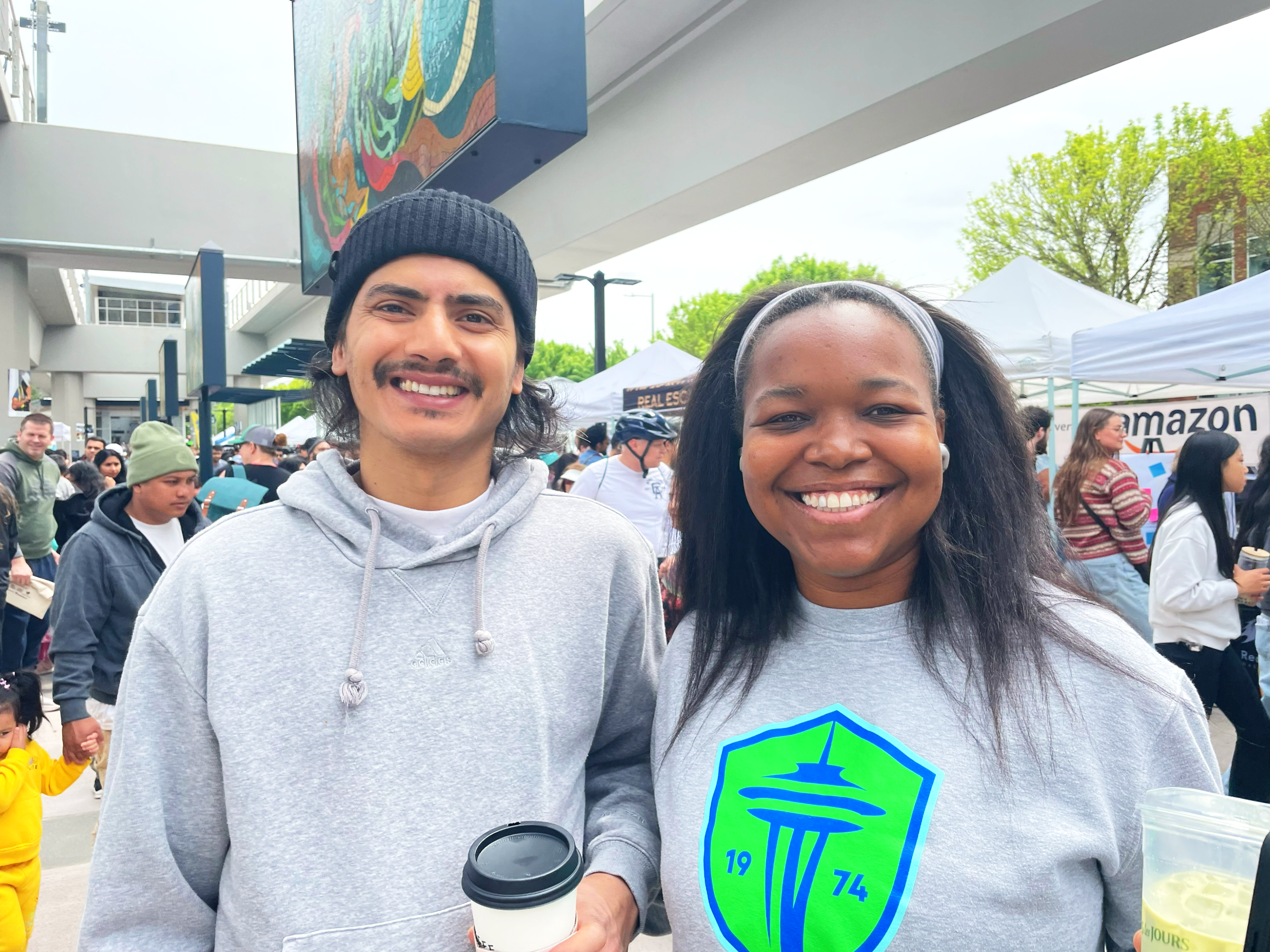 Yara-Downtown-Redmond Photo of two people smiling at the light rail opening celebration.