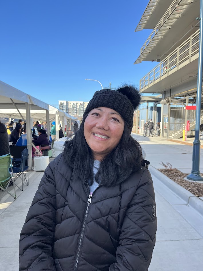 A woman in a black puffy jacket and hat