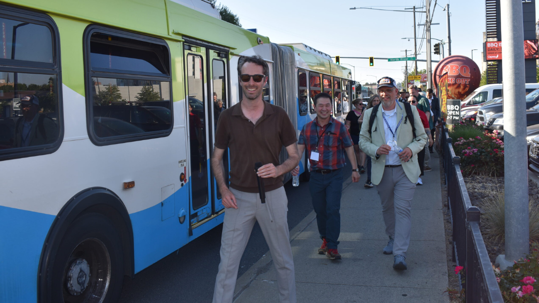 Public officials prepare to cut a ribbon at the grand opening of the Swift Orange Line bus rapid transit. 
