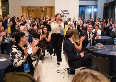A raffle winner runs to the stage to claim her prize.