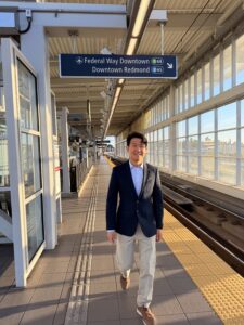 Microsoft employee Eugene Kim stands at a light rail station. 
