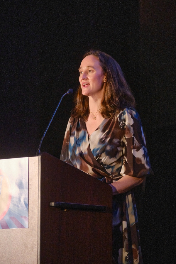 Seattle Mayor Katie Wilson stands at a podium to give a speech. 