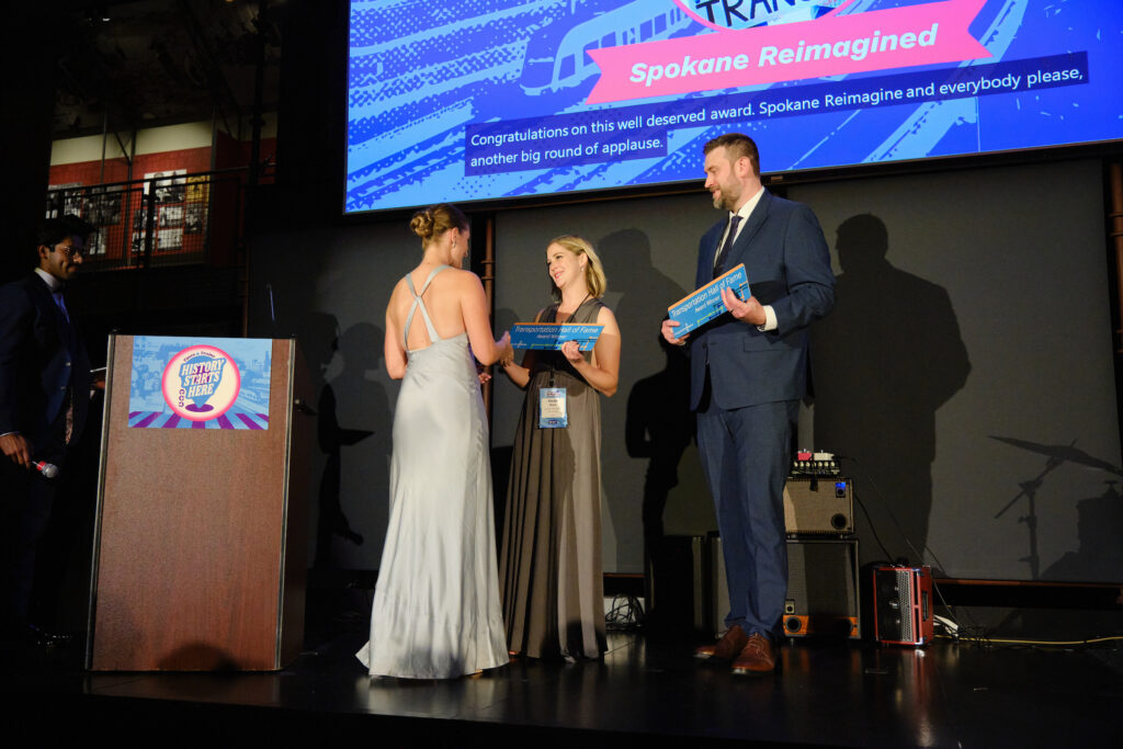 Sarah Rose and Erik Lowe from Spokane Reimagined accept their Transportation Choices Hall of Fame award from Katy Ricchiuto.